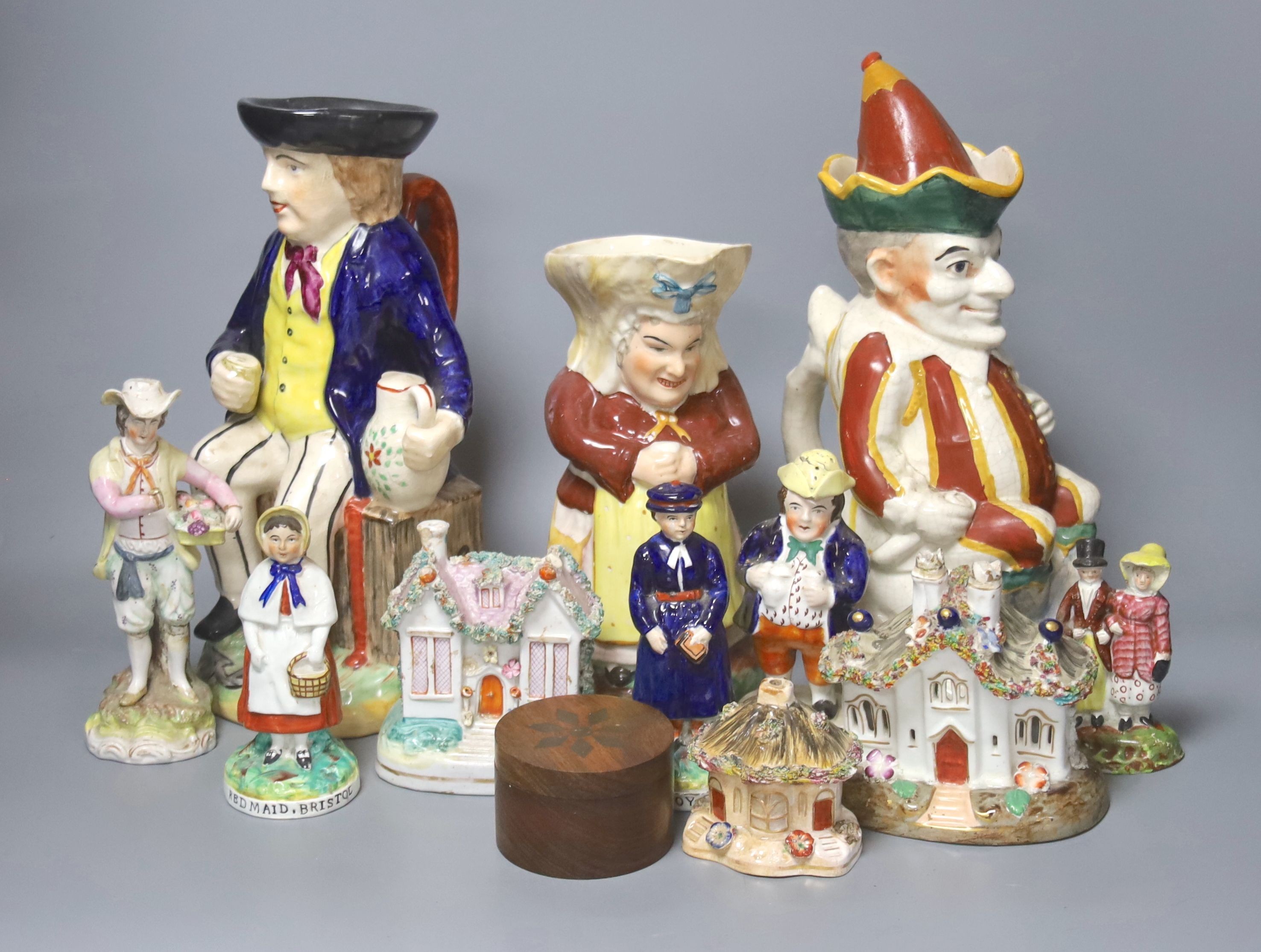A group of assorted 19th century and later Staffordshire ceramics including a Toby jug, Colston Boy and Red Maid Girl Bristol